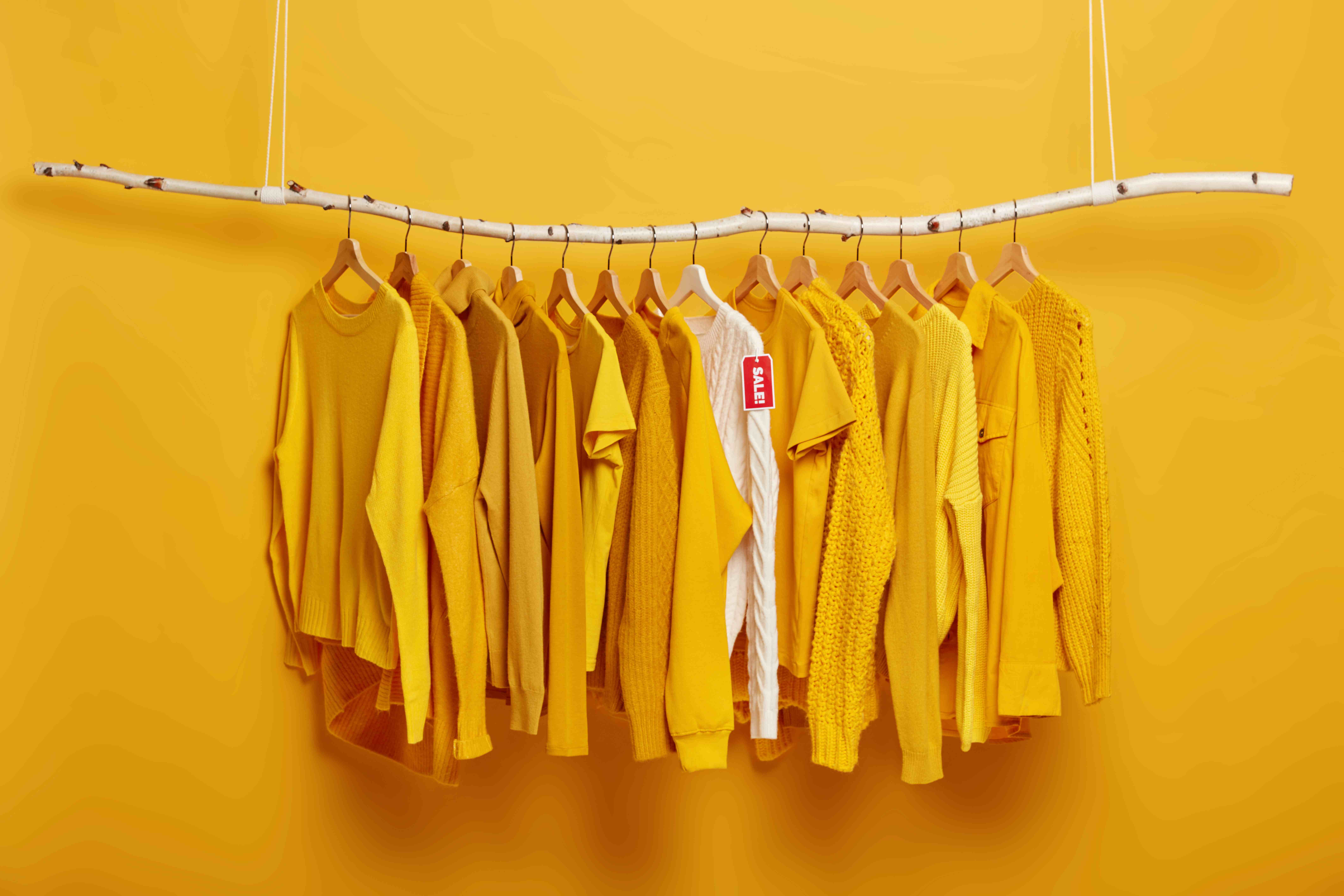 black-friday-shopping-big-sales-concept-detail-image-yellow-clothes-white-sweater-with-label-tag-hanging-rack-clothing-store_11zon.jpg